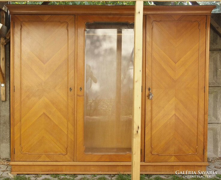 Three-door wardrobe with polished-faceted glass in the middle