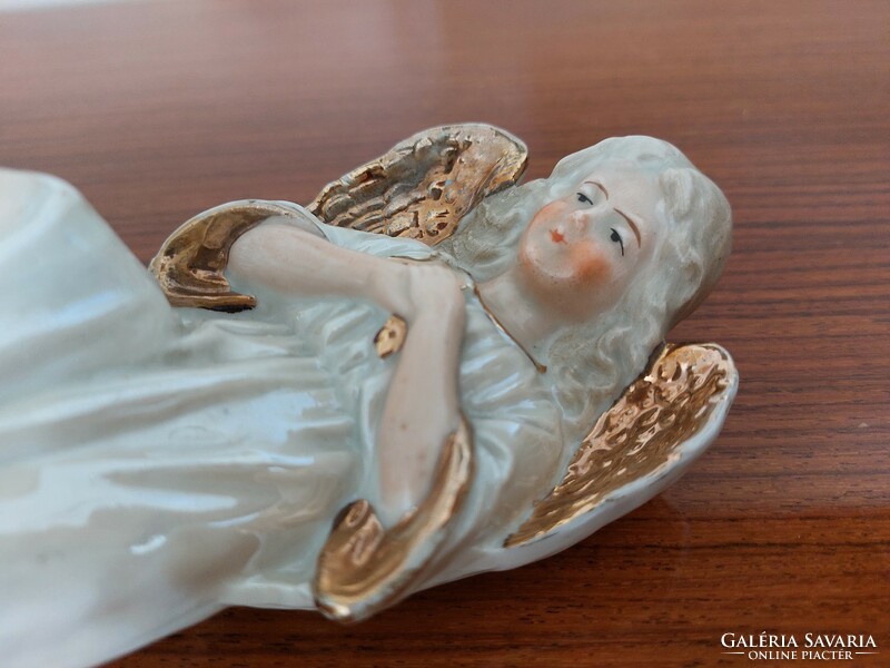 Old porcelain angel with golden wings vintage statue