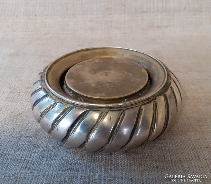 A table ornament /ashtray/ that can also be used as an ashtray depicting an old copper rare car tire