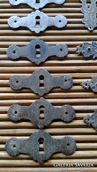 Various antique hammered, chiseled lock covers, 12 in total