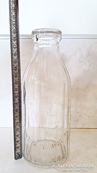 Old milk glass milk bottle with ribbed walls, stork pattern