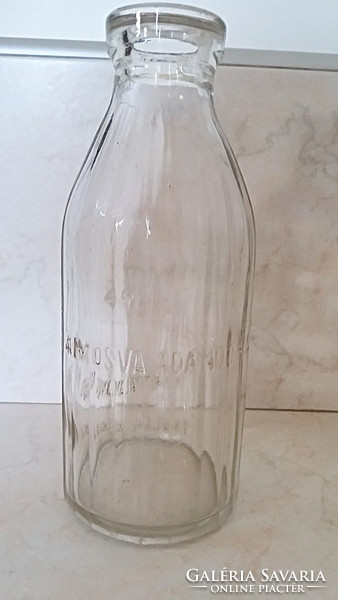 Old milk glass milk bottle with ribbed walls, stork pattern