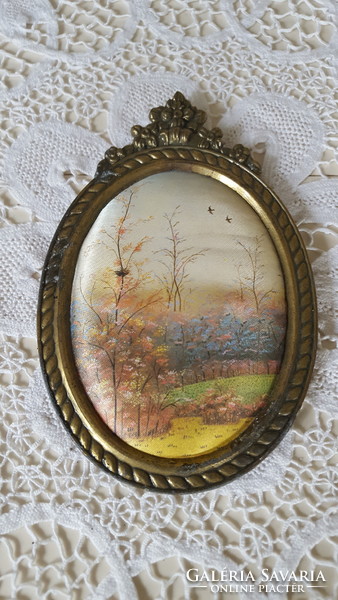 Old silk picture in a bronze-colored metal frame