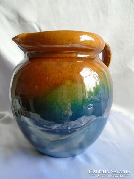 Gradient blue-green-brown ceramic jug.