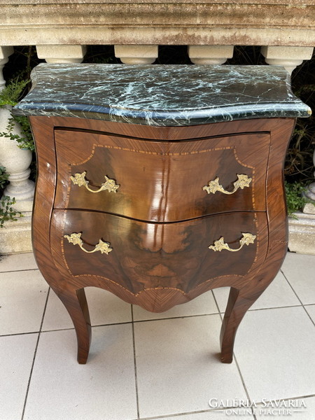 A small dresser with a marble top in a nice shape