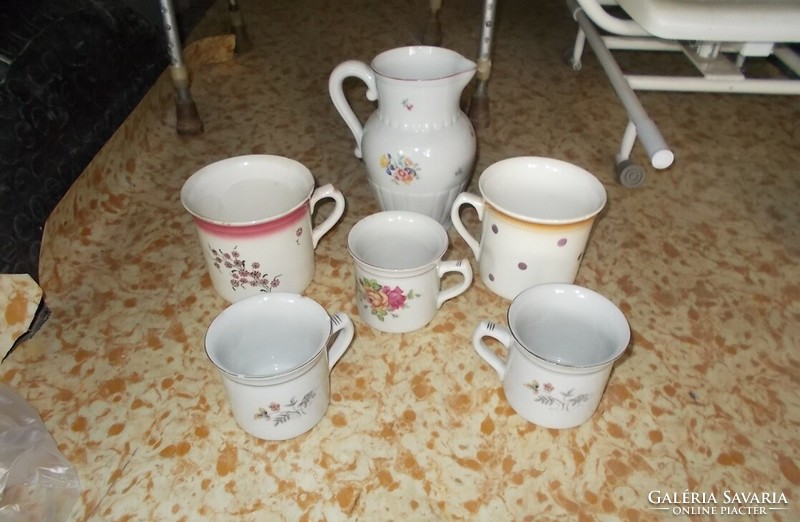 Porcelain jugs and mugs with polka dots and flowers.