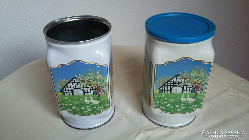 Two old metal / tin boxes with rural buildings on the side (there is only one roof)