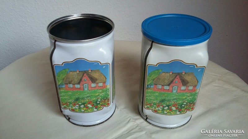 Two old metal / tin boxes with rural buildings on the side (there is only one roof)