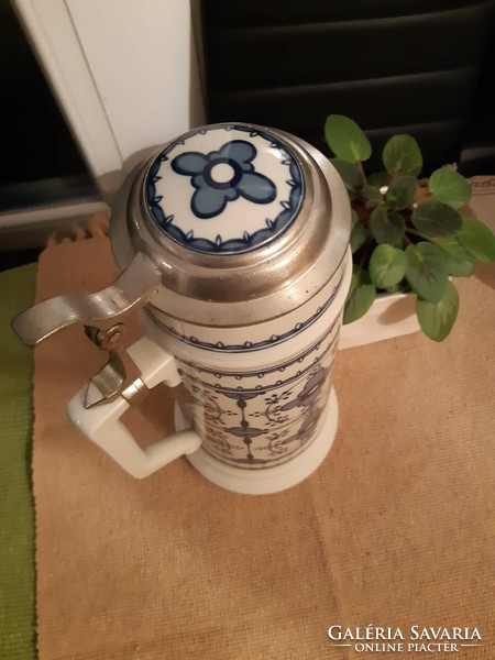 A giant ceramic jug with a tin lid with a ceramic insert