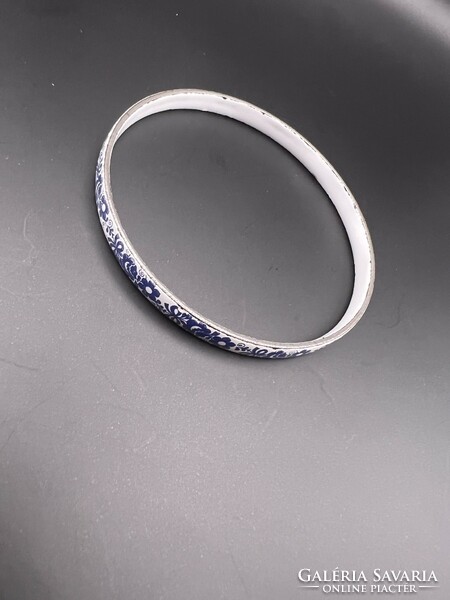 Fire enamel bracelet with a blue flower pattern on a white background