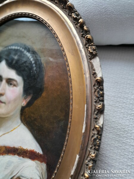Female portrait painting, in an oval frame
