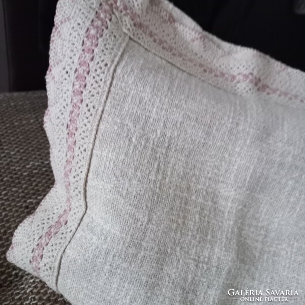 Old woven decorative cushion with lace edge