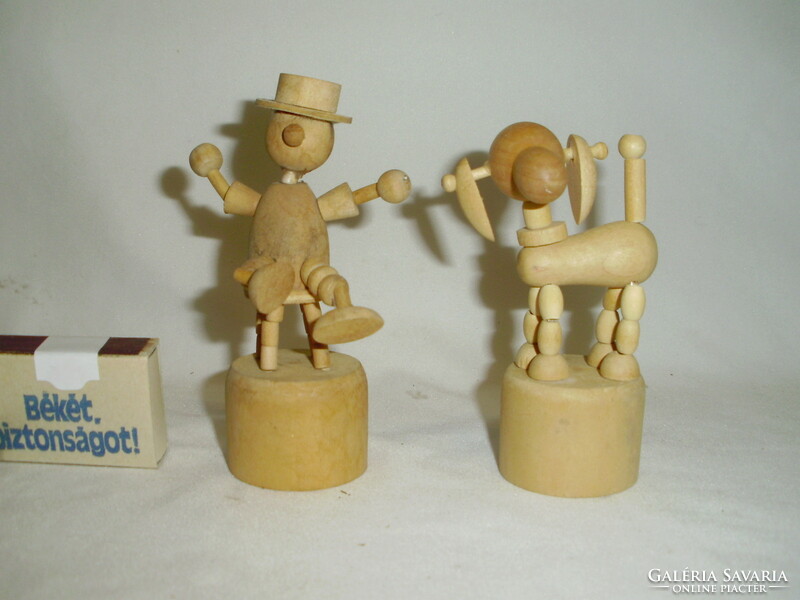 Two movable wooden toy figures together - dog, man