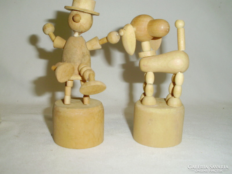 Two movable wooden toy figures together - dog, man