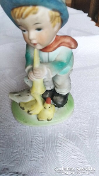A boy with a flute and a duck