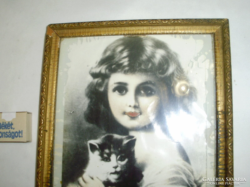 Old glazed picture frame with a picture of a little girl with a kitten