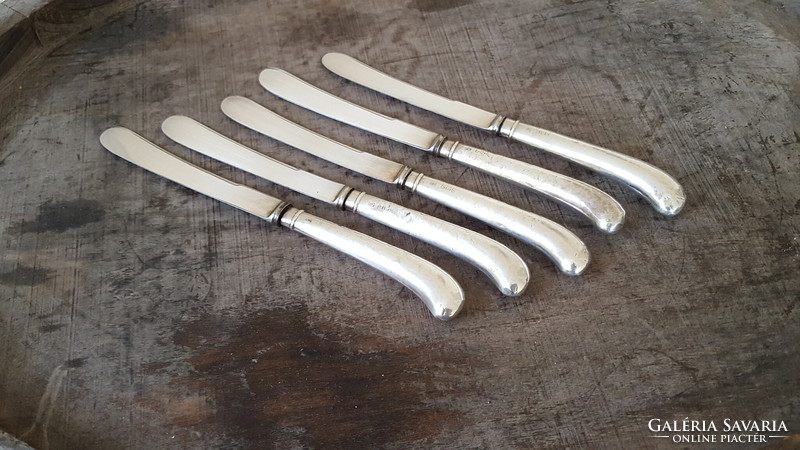 5 silver-handled English dessert or butter knives.