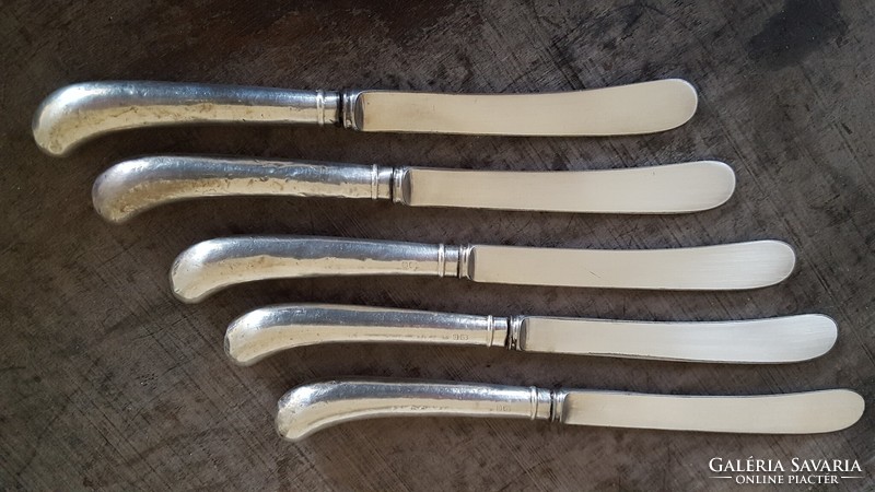 5 silver-handled English dessert or butter knives.