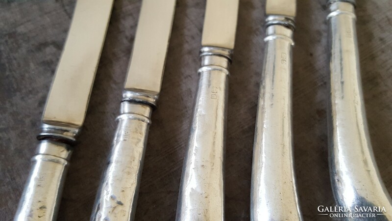 5 silver-handled English dessert or butter knives.