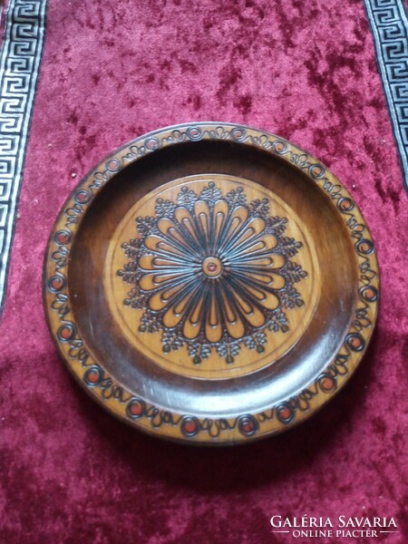 A wooden bowl with a burnt pattern