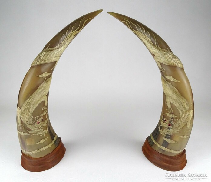 1H188 large carved dragon patterned horns pair of horns on wooden pedestal 34 cm