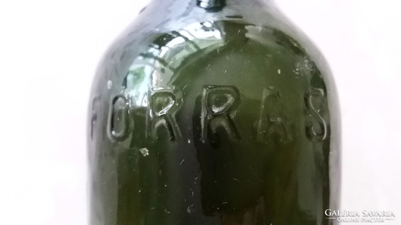 Old bottle of mossy magnes source with inscription mineral water in green glass