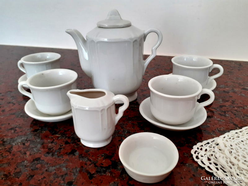 Old toy porcelain tea set with crochet small tablecloth
