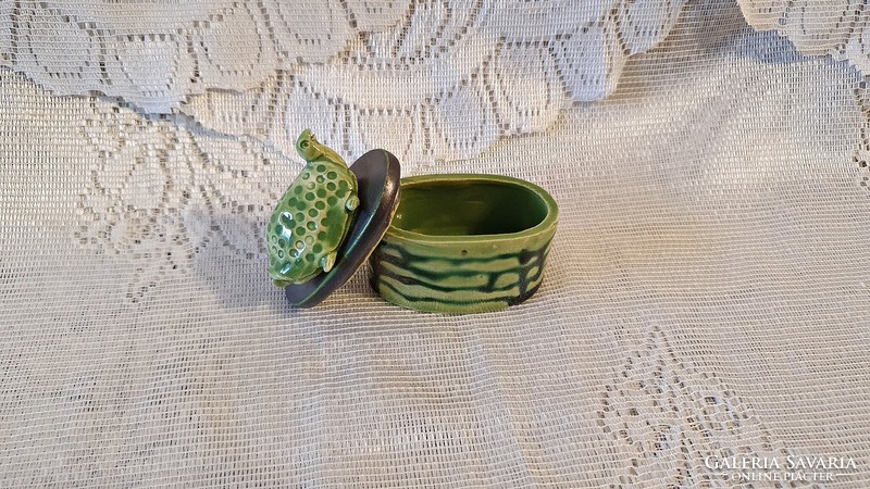 Old, oval-shaped, green, ceramic bonbonier with a tortoise figure on top.