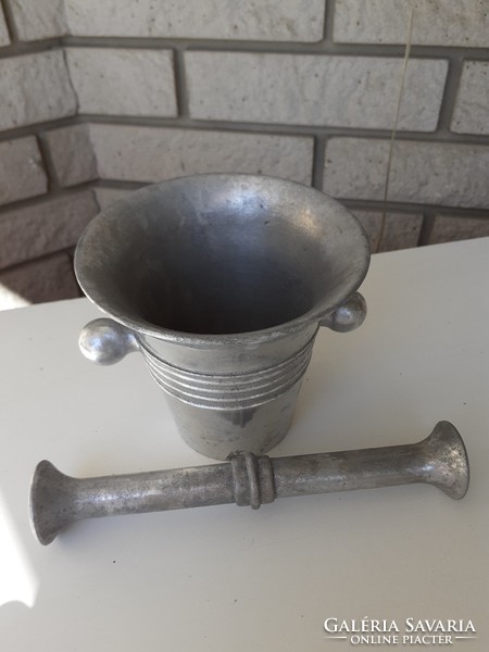 Old aluminum mortar and pestle with confectioner tool