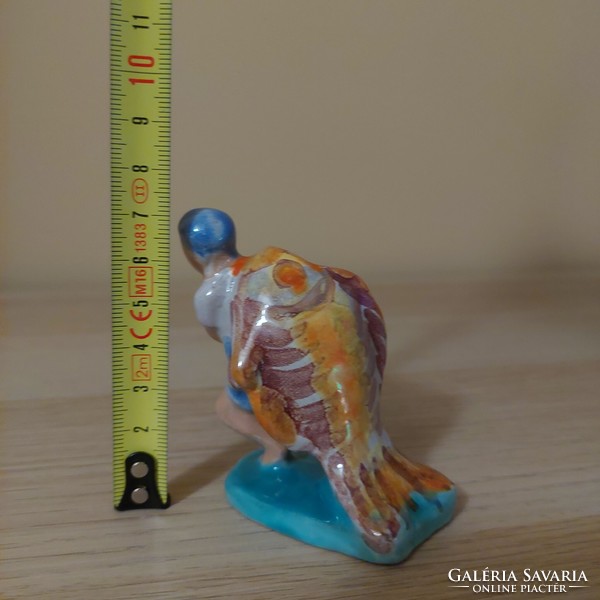 Industrial ceramic figure of a boy carrying a fish