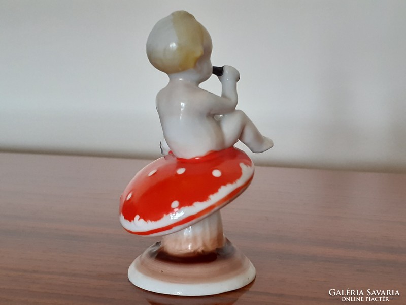 Old metzler & ortloff baby sitting on miniature porcelain mushrooms