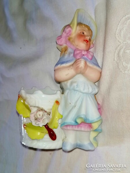 Old figurative spice holder. A little girl in a headscarf praying
