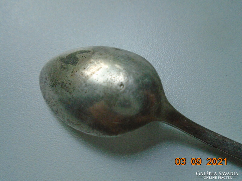 Antique silver-plated teaspoon with several markings