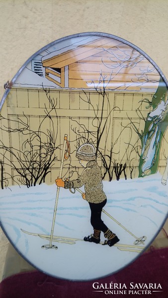 A wall painting painted on a glass depicting a little boy skiing in a beautiful old Art Nouveau winter scene!