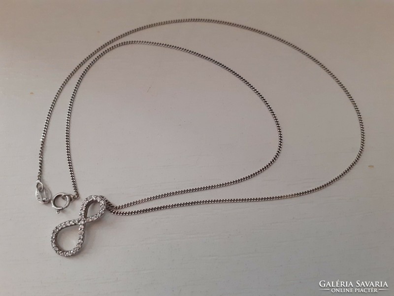 Marked silver chain with a mark on it and a sparkling tiny cubic zirconia stone infinity sign pendant