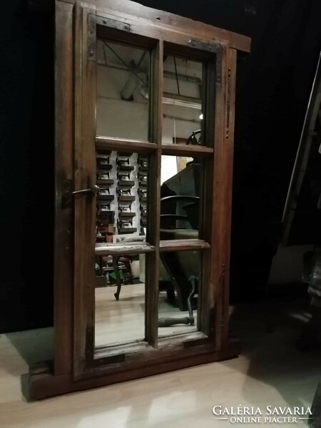 Old mirrored window, early 20th century small window as a mirror, old pine window
