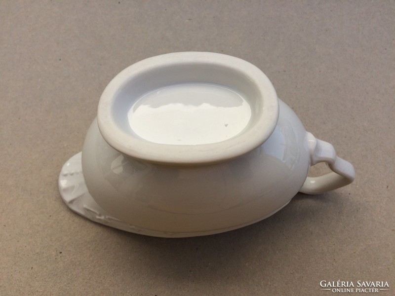 Old white porcelain sauce serving sauce bowl pouring