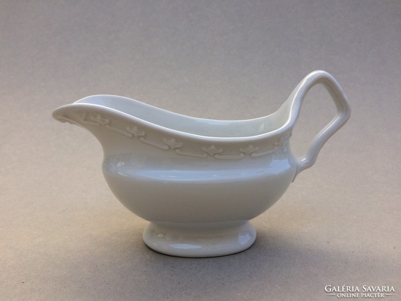 Old white porcelain sauce serving sauce bowl pouring