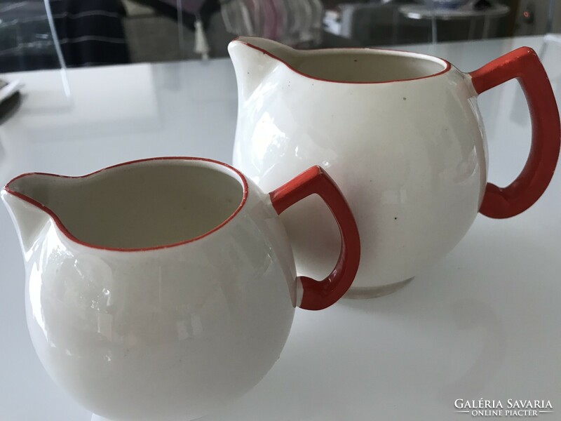 Art deco Czech ceramic pitchers in eggshell color with bright red handles