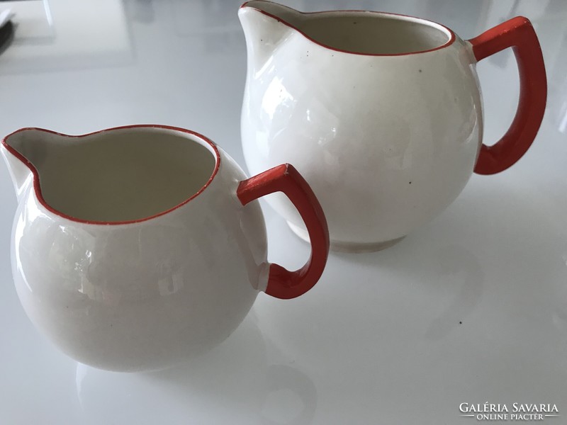 Art deco Czech ceramic pitchers in eggshell color with bright red handles