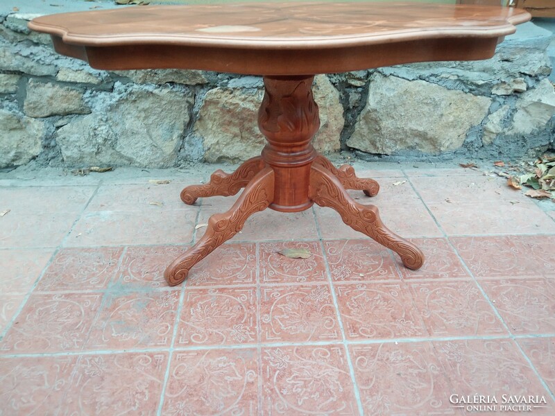 A richly carved baroque coffee table with fabulous inlaid spider legs