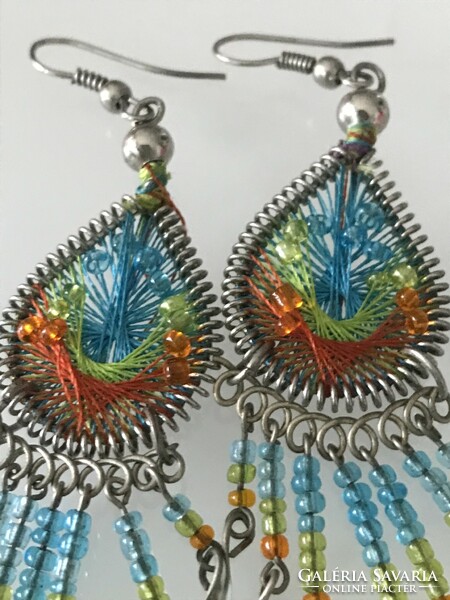Handmade earrings made of colorful thread and pearls
