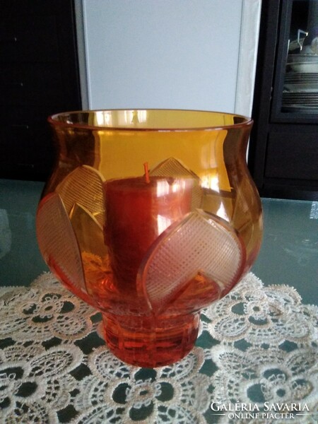 Modern candle holder - vase in orange color, with a detailed pattern around the side.