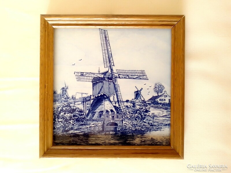 Dutch ceramic faience decorative tile in a wooden frame, marked, royal moss, windmill canal coast landscape