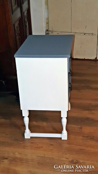An old bedside table or a small dresser..