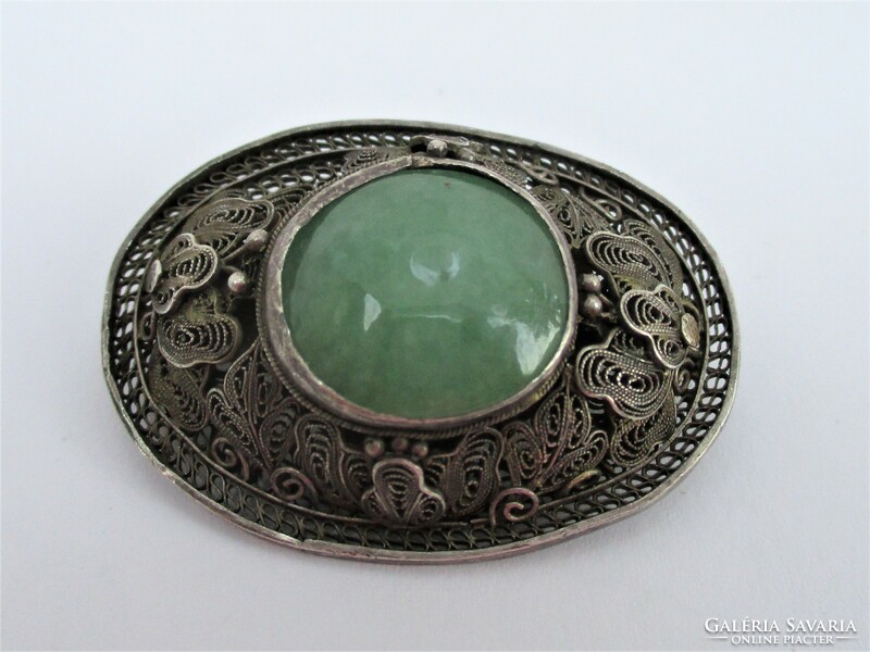 A wonderful antique silver brooch with a large jade stone