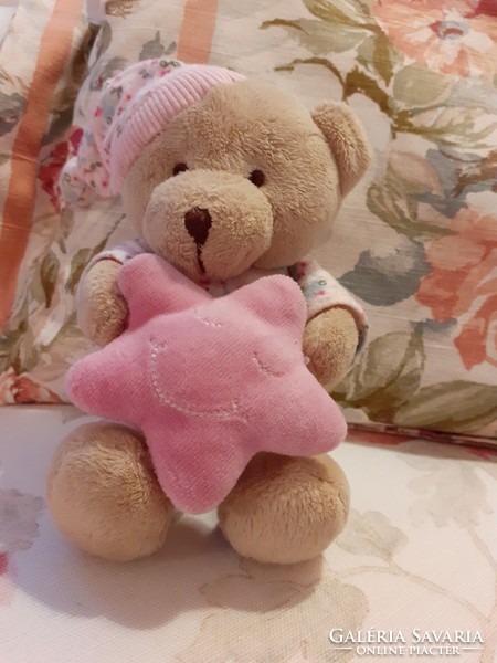 Teddy bear - early days plush bear in pajamas with a cap and a pink star in his hand