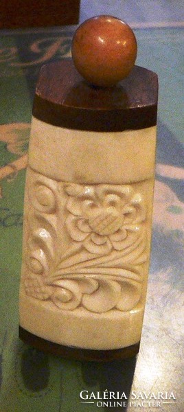 Marked carved bone holder with lid.