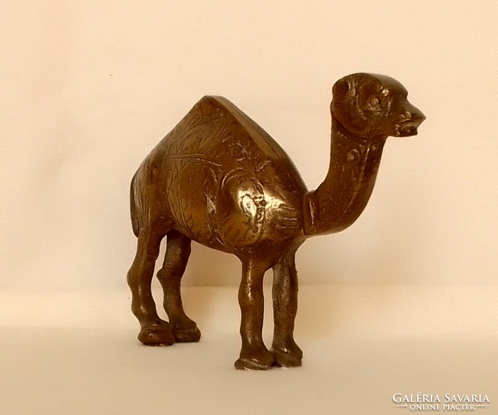 Old copper one-humped camel dromedary animal figure statue with carved pattern on the side of Arabian African desert