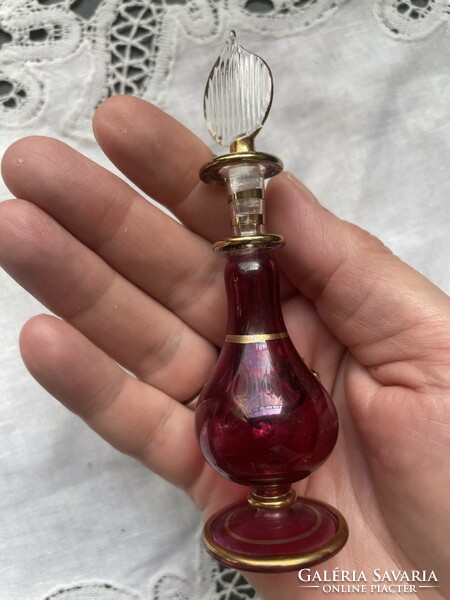 A beautiful, breath-thin handmade gilded perfume bottle